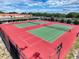 Aerial view showcasing multiple tennis courts on a sunny day at 7353 Thorpp Ave, Brooksville, FL 34613