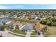 Aerial view of a home in a neighborhood featuring a serene pond and lush landscaping at 7523 Tangle Brook Blvd, Gibsonton, FL 33534