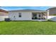 Expansive backyard with a well-kept lawn, offering ample space for outdoor activities and relaxation at 7523 Tangle Brook Blvd, Gibsonton, FL 33534