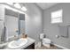 Neutral bathroom featuring tile flooring, granite countertop, modern lighting and a white toilet at 7523 Tangle Brook Blvd, Gibsonton, FL 33534