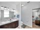 Bathroom with a double sink vanity and a toilet, connecting to the main bedroom at 7523 Tangle Brook Blvd, Gibsonton, FL 33534