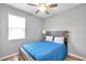 Cozy bedroom with wood-look flooring, a comfortable bed, and a bright window at 7523 Tangle Brook Blvd, Gibsonton, FL 33534