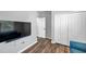 Modern bedroom with an entertainment system, wood-look flooring and a closet at 7523 Tangle Brook Blvd, Gibsonton, FL 33534