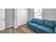 This cozy bedroom is furnished with a large couch, wood-look flooring and a closet at 7523 Tangle Brook Blvd, Gibsonton, FL 33534
