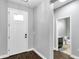 Clean and bright entryway with a white front door, gray walls, and wood-look tile flooring at 7523 Tangle Brook Blvd, Gibsonton, FL 33534