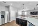 Modern kitchen with a large center island, dark cabinets, stainless steel appliances, and open layout at 7523 Tangle Brook Blvd, Gibsonton, FL 33534