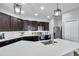 Modern kitchen featuring dark cabinetry, stainless steel appliances, a kitchen island, and recessed lighting at 7523 Tangle Brook Blvd, Gibsonton, FL 33534