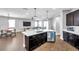 Modern kitchen with a large center island, dark cabinets, stainless steel appliances, and open layout at 7523 Tangle Brook Blvd, Gibsonton, FL 33534