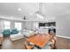 Open-concept living space with modern dining set, comfortable seating, and a view of the contemporary kitchen at 7523 Tangle Brook Blvd, Gibsonton, FL 33534