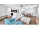 Spacious living room featuring modern furnishings, wood flooring, and an open floor plan to the kitchen and dining area at 7523 Tangle Brook Blvd, Gibsonton, FL 33534