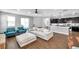Bright living room with sliding glass doors, plush seating, and open concept layout at 7523 Tangle Brook Blvd, Gibsonton, FL 33534