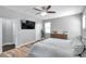 Relaxing main bedroom with a wall-mounted TV, modern dresser, and a view into an ensuite bathroom at 7523 Tangle Brook Blvd, Gibsonton, FL 33534