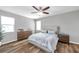 Calm and inviting bedroom featuring wood floors, a ceiling fan, and soft, neutral colors at 7523 Tangle Brook Blvd, Gibsonton, FL 33534