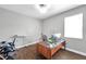 Modern office with two desks, wood-look flooring, natural light and neutral decor at 7523 Tangle Brook Blvd, Gibsonton, FL 33534