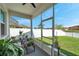 Enclosed patio offers lovely views of the fenced yard with lush landscaping, offering privacy at 7523 Tangle Brook Blvd, Gibsonton, FL 33534