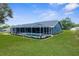 Beautiful backyard view featuring a screened-in pool and patio area, complemented by lush greenery and landscaping at 8084 Nightingale Rd, Weeki Wachee, FL 34613