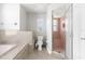 Bathroom featuring a walk-in shower, toilet, and bathtub at 8084 Nightingale Rd, Weeki Wachee, FL 34613