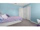 Charming blue bedroom with a cozy bed, closet, and comfortable atmosphere at 8084 Nightingale Rd, Weeki Wachee, FL 34613