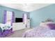 Bright bedroom featuring a comfortable bed, a chair, and plenty of storage space at 8084 Nightingale Rd, Weeki Wachee, FL 34613