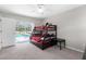 Bright bedroom with bunk bed, connecting to outdoor pool area with sliding glass door at 8084 Nightingale Rd, Weeki Wachee, FL 34613