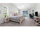 Bright bedroom with neutral colors, ensuite desk and sliding glass doors leading to a pool at 8084 Nightingale Rd, Weeki Wachee, FL 34613