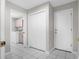 Hallway view with easy access to the laundry room, featuring tile flooring and closet space for storage at 8084 Nightingale Rd, Weeki Wachee, FL 34613