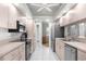 Updated kitchen features stainless steel appliances, tile backsplash, and recessed lighting at 8084 Nightingale Rd, Weeki Wachee, FL 34613