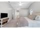 Bright bedroom featuring gray walls, vaulted ceilings, a queen-sized bed, and a small shelf at 8084 Nightingale Rd, Weeki Wachee, FL 34613