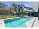 Lovely screened pool with covered patio and landscaped surroundings for a relaxing experience at 8084 Nightingale Rd, Weeki Wachee, FL 34613