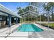 Inviting screened pool with spacious deck, outdoor seating, and a view of lush greenery at 8084 Nightingale Rd, Weeki Wachee, FL 34613