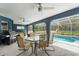Inviting covered patio with seating area and grill overlooking the sparkling pool at 8084 Nightingale Rd, Weeki Wachee, FL 34613