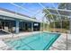 Inviting screened pool area with comfortable seating and dining, perfect for outdoor entertaining at 8084 Nightingale Rd, Weeki Wachee, FL 34613