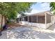 Spacious backyard featuring a screened-in porch and concrete patio, perfect for outdoor entertaining at 8634 Roble Way, Port Richey, FL 34668