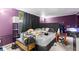 Spacious bedroom with plush carpet, dramatic purple walls, and a cozy seating area at 8634 Roble Way, Port Richey, FL 34668