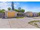 Inviting single-story home featuring two garages, mature landscaping, and a long driveway at 8634 Roble Way, Port Richey, FL 34668