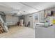 Bright garage with washer, dryer, storage racks, and shelving for organization and convenience at 8634 Roble Way, Port Richey, FL 34668
