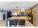 Modern kitchen featuring stainless steel appliances, island with seating, and ample storage for a chef's delight at 8634 Roble Way, Port Richey, FL 34668