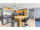 Well-appointed kitchen boasts stainless steel appliances, ample counter space, and a center island with seating at 8634 Roble Way, Port Richey, FL 34668