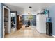 Kitchenette with blue walls, tile flooring, and backyard view at 8634 Roble Way, Port Richey, FL 34668