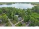 An aerial view of a house surrounded by a canopy of large trees, and water views in the distance at 8755 Marigold Dr, New Port Richey, FL 34654