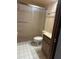 Bathroom features a shower with sliding glass door, toilet and vanity with sink at 8755 Marigold Dr, New Port Richey, FL 34654