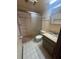 Bathroom features shower, toilet and vanity with sink and mirror at 8755 Marigold Dr, New Port Richey, FL 34654