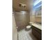 Bathroom features shower, toilet and vanity with sink and mirror at 8755 Marigold Dr, New Port Richey, FL 34654