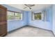Bedroom with carpeted floors, a ceiling fan, and natural light at 8755 Marigold Dr, New Port Richey, FL 34654