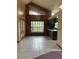 Open dining space features neutral tile, grand chandelier, large window, and access to kitchen at 8755 Marigold Dr, New Port Richey, FL 34654