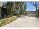 A view of the home's driveway, detached garage, and ample parking space at 8755 Marigold Dr, New Port Richey, FL 34654