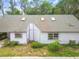 Single-story home featuring a gray roof, skylights, a purple trim, and manicured landscaping at 8755 Marigold Dr, New Port Richey, FL 34654