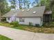 A single-story home featuring a gray roof and trimmed landscaping at 8755 Marigold Dr, New Port Richey, FL 34654