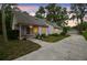 Charming single-story home with a long driveway, detached garage, and mature trees creating a peaceful setting at 8755 Marigold Dr, New Port Richey, FL 34654