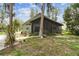 Charming home with screened porch, mature trees, and landscaped yard at 8755 Marigold Dr, New Port Richey, FL 34654